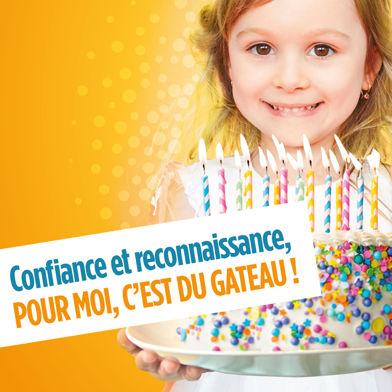 Gros plan sur une petite fille qui tient un gateau d'anniversaire avec plein de bougies dessus